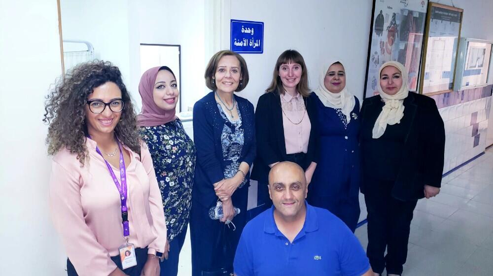 Visitors pose in front of the Safe Women's Clinic